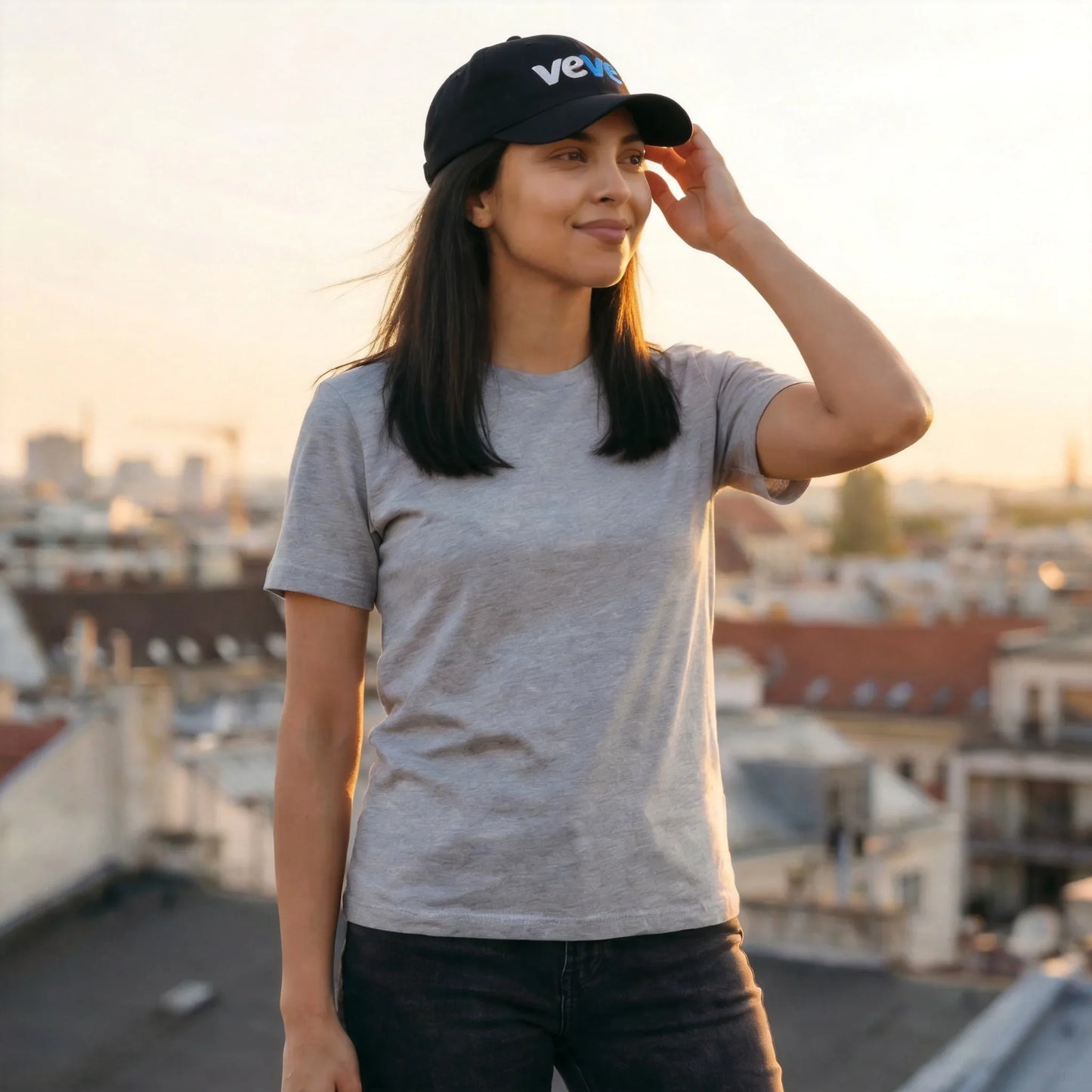 Veve Digital Collectibles New Logo Dad Hat — modeled at outdoor rooftop, black dad hat worn naturally with veVe embroidery