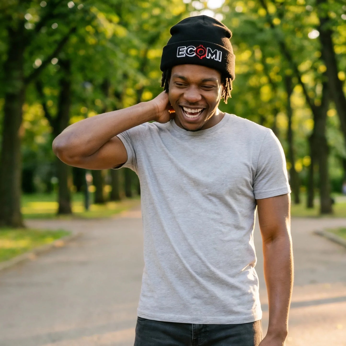Ecomi Text Logo Cuffed Beanie — modeled at outdoor park, black beanie with ECOMI embroidery worn naturally