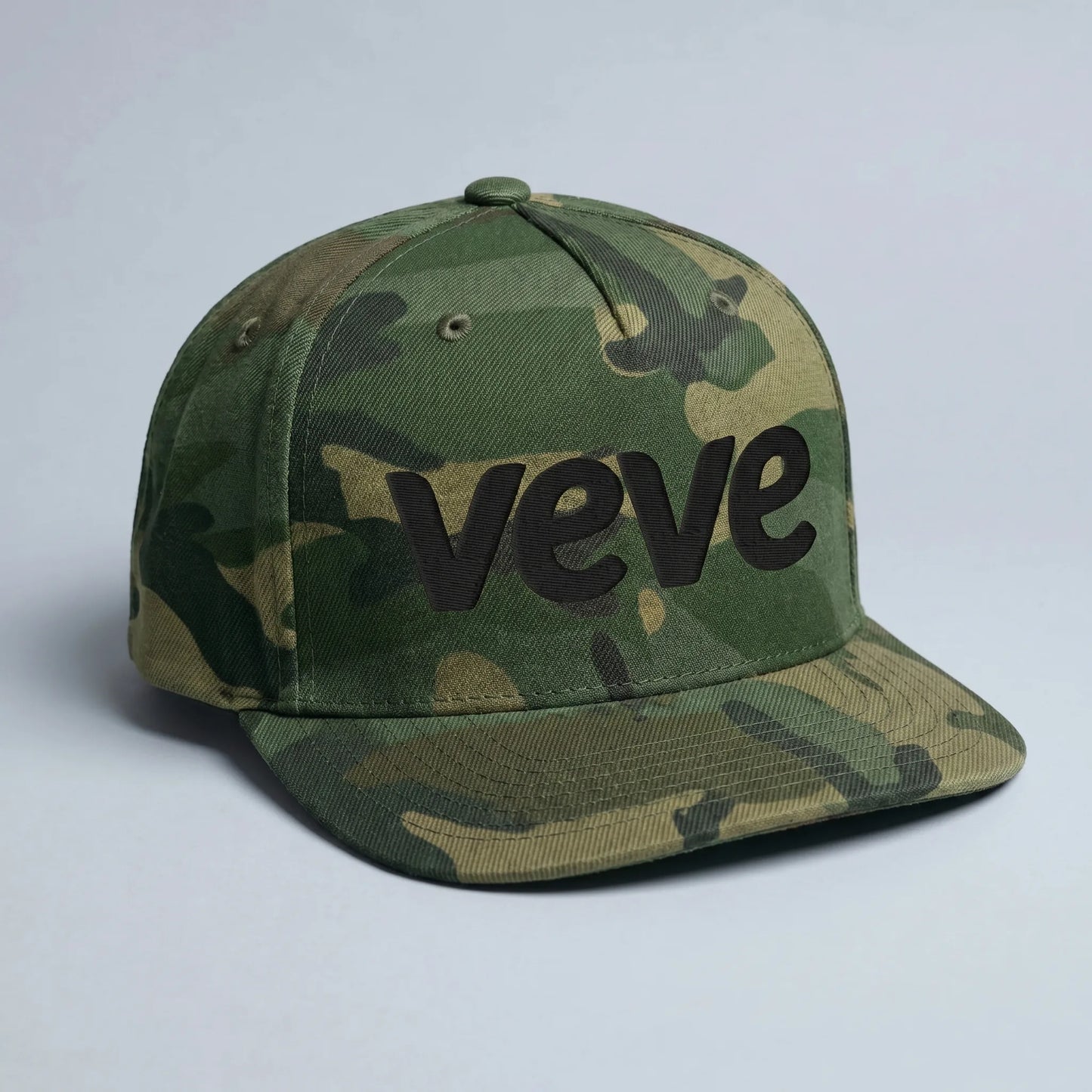 Veve Logo Camo Snapback Hat Black — front view from Common Club, VeVe logo embroidered on green camo flat-bill snapback