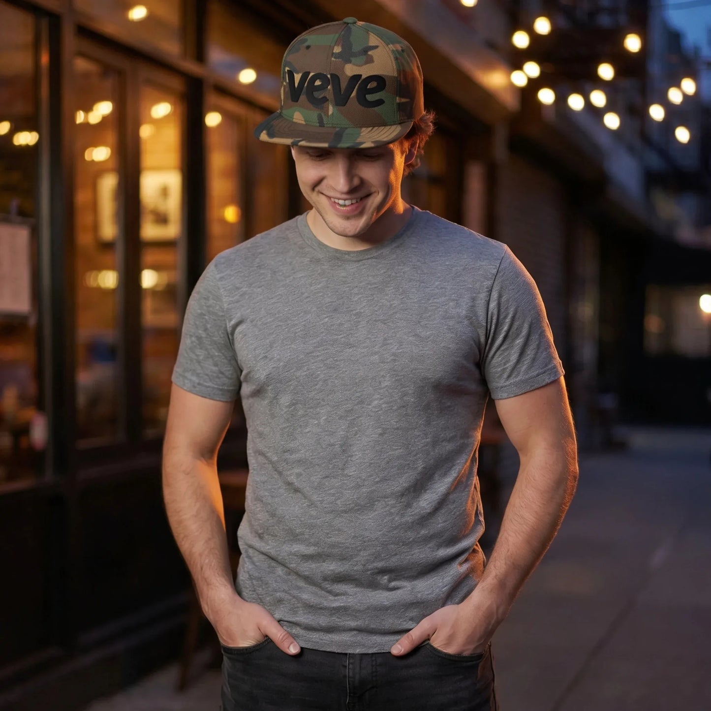 Veve Logo Camo Snapback Hat Black — modeled at urban-night-restaurant, camo snapback in warm evening setting