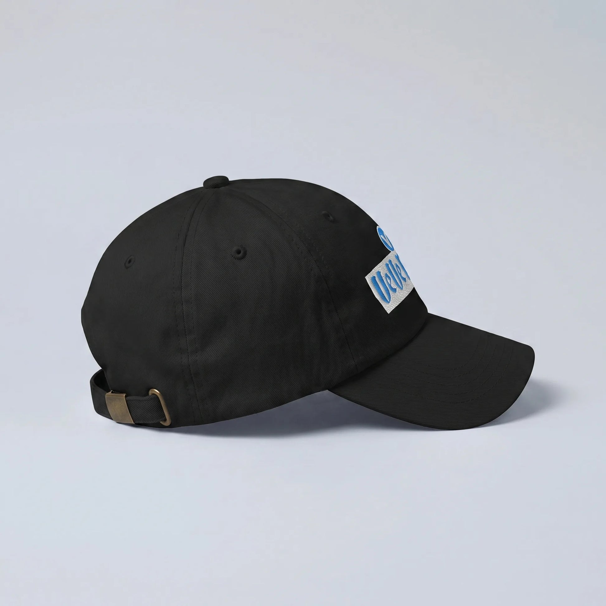 VeVe Magic Dad Hat — side view from Common Club, black dad hat with pre-curved bill and brass buckle strap