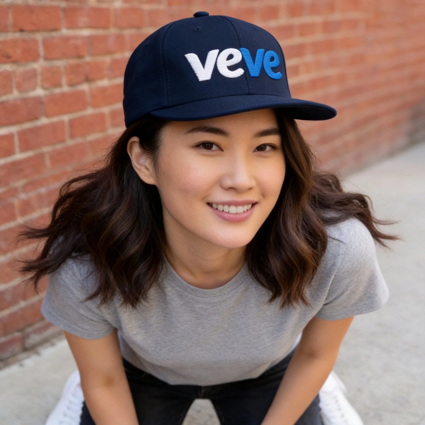 VeVe New Logo Snapback Hat — modeled at urban-day-wall, navy snapback with veVe logo worn naturally
